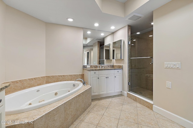 bathroom featuring tile patterned flooring, vanity, and plus walk in shower