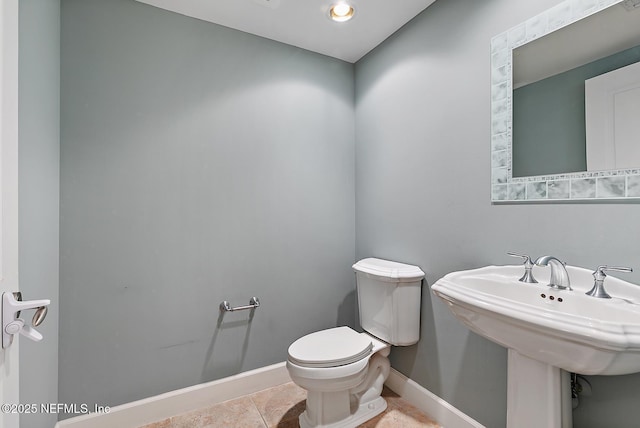 bathroom with tile patterned floors, toilet, and sink