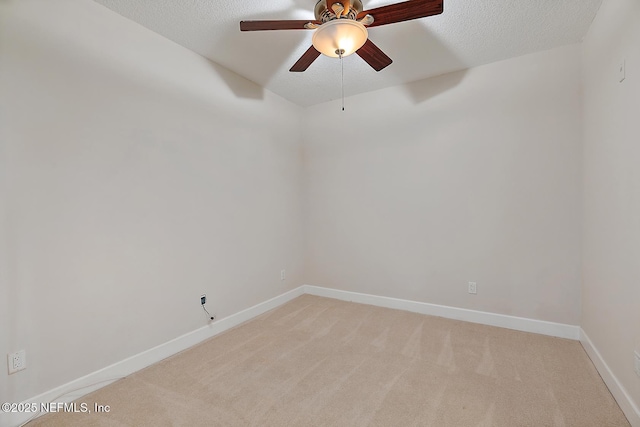 unfurnished room with light carpet, ceiling fan, and a textured ceiling