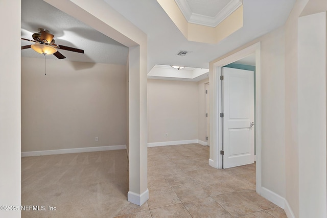 corridor featuring crown molding and a tray ceiling