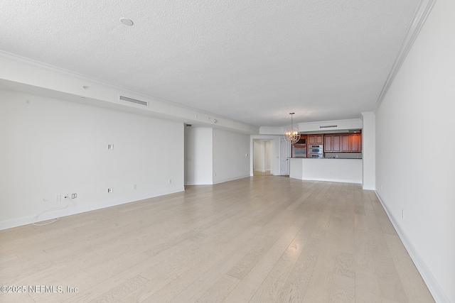 unfurnished living room with visible vents, a notable chandelier, light wood-style flooring, ornamental molding, and a textured ceiling