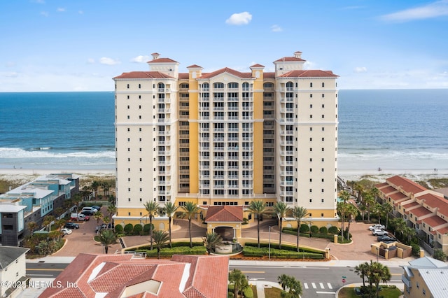 view of building exterior with a view of the beach and a water view