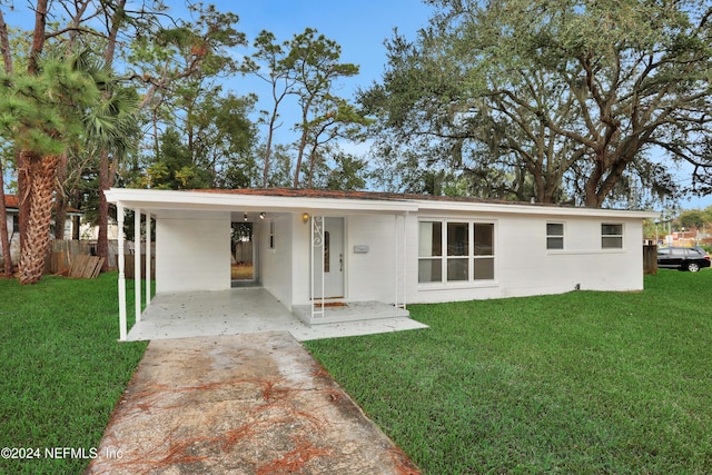 exterior space featuring a front lawn and a carport