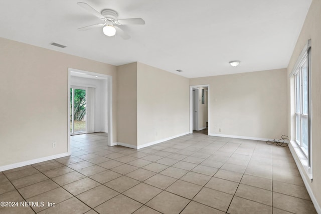 tiled empty room with ceiling fan