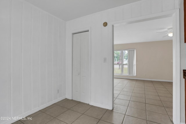 unfurnished room with ceiling fan and light tile patterned floors