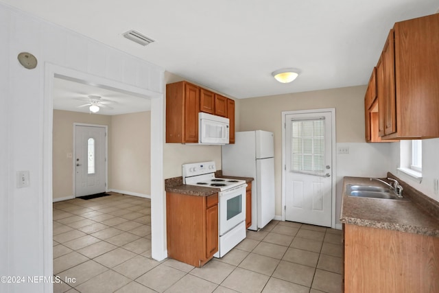 kitchen featuring ceiling fan, light tile patterned flooring, white appliances, and sink