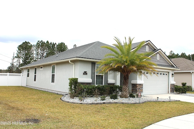 ranch-style home featuring a garage and a front lawn