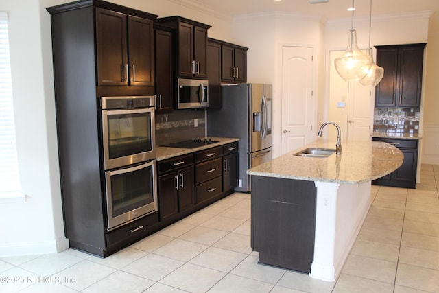 kitchen featuring light stone countertops, backsplash, stainless steel appliances, sink, and decorative light fixtures