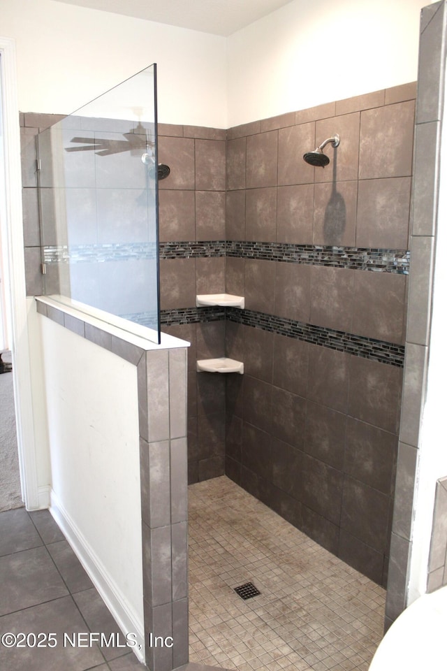 bathroom with tile patterned floors and tiled shower