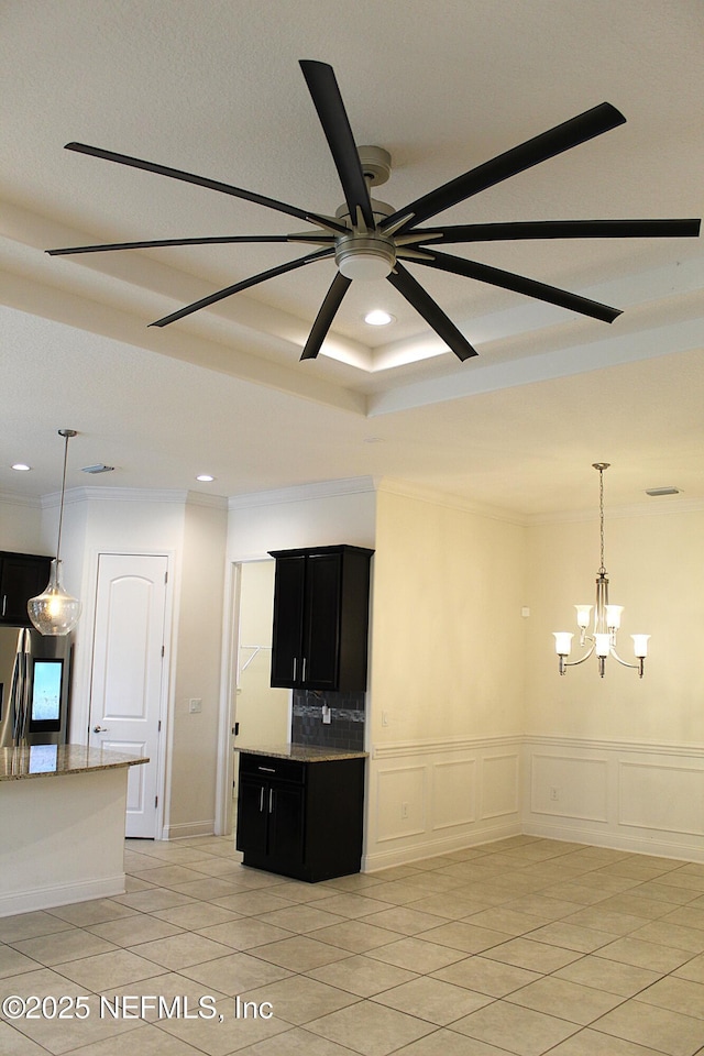 unfurnished living room featuring ceiling fan with notable chandelier, crown molding, and light tile patterned flooring