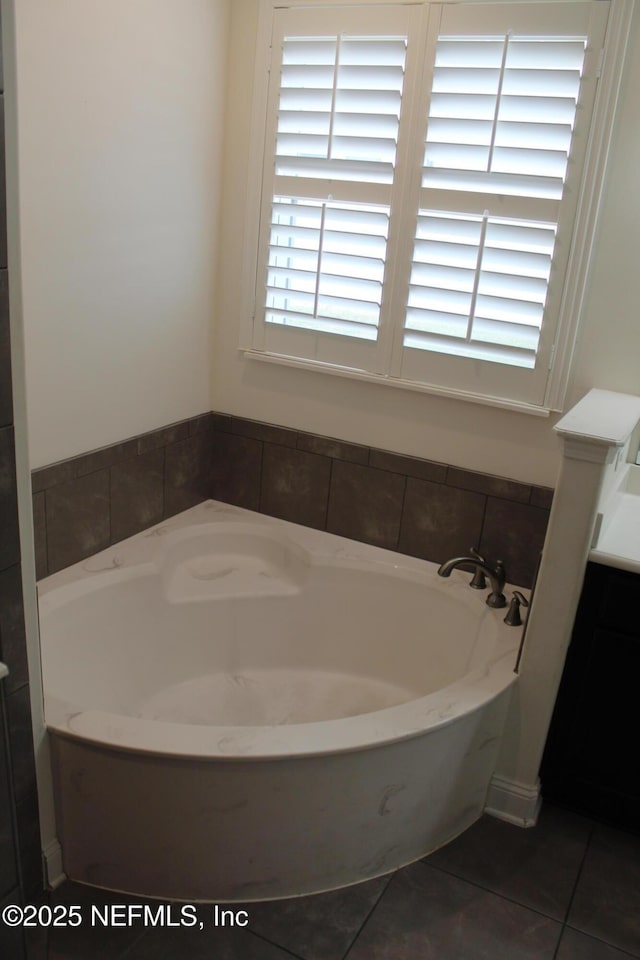 bathroom featuring tile patterned floors and a tub