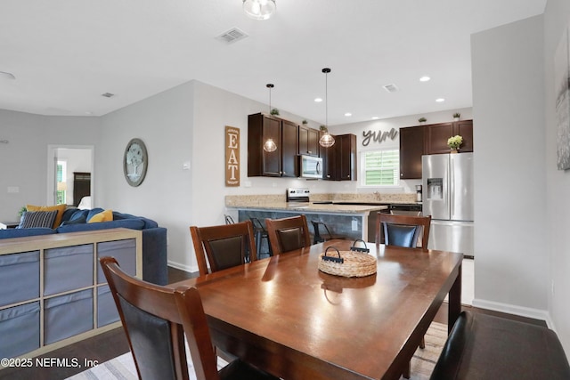 dining room with dark wood-type flooring