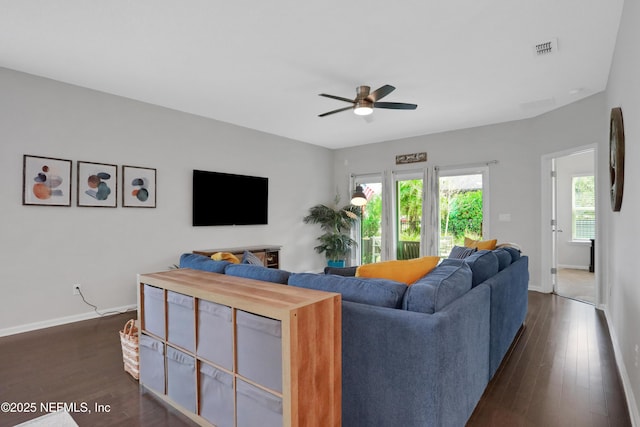 living room with dark wood-type flooring and ceiling fan