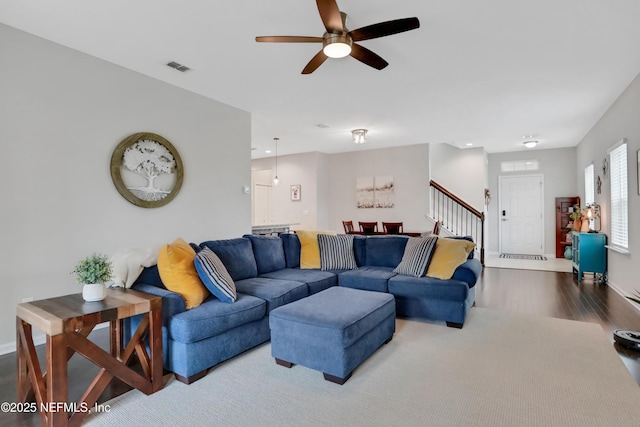 living room with wood-type flooring and ceiling fan