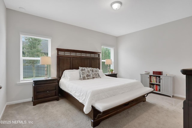 carpeted bedroom featuring multiple windows