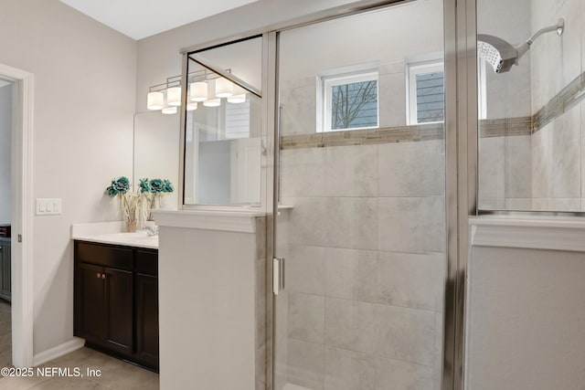 bathroom featuring vanity, walk in shower, and tile patterned flooring