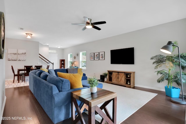 living room with ceiling fan and dark hardwood / wood-style floors