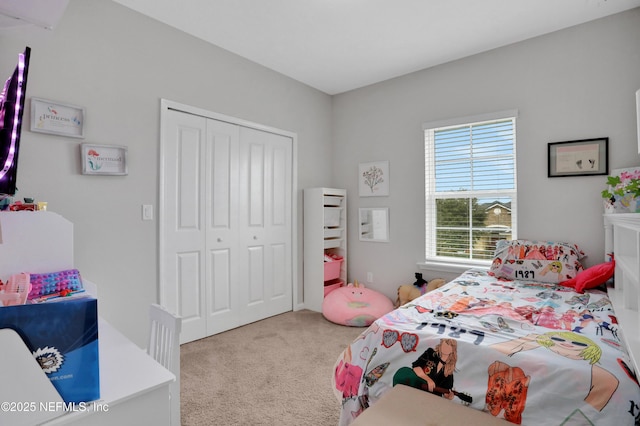 bedroom featuring light colored carpet and a closet