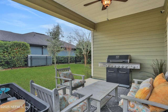 view of patio / terrace with area for grilling, ceiling fan, and an outdoor living space