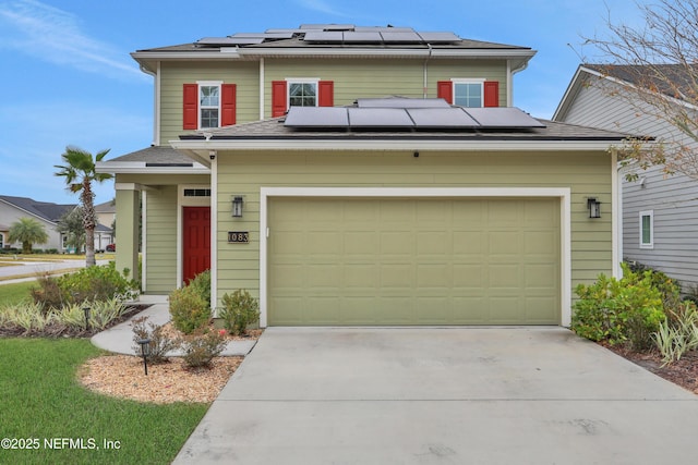 view of front of home with a garage and solar panels