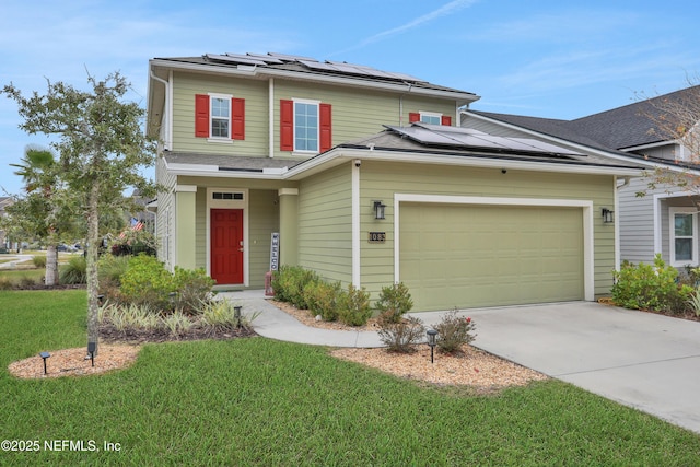 view of front property featuring solar panels, a front lawn, and a garage