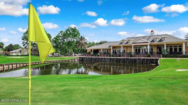 surrounding community featuring a lawn and a water view