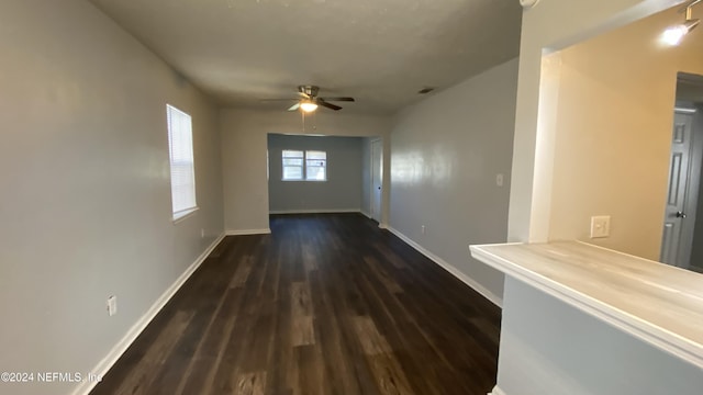 unfurnished room featuring ceiling fan and dark hardwood / wood-style flooring