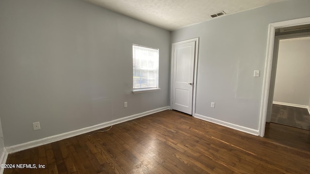 unfurnished bedroom featuring dark hardwood / wood-style floors