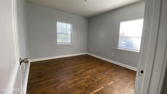 spare room featuring dark wood-type flooring