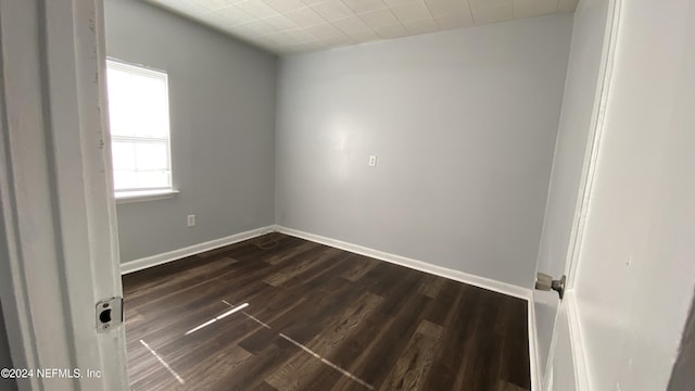 unfurnished room featuring dark hardwood / wood-style flooring