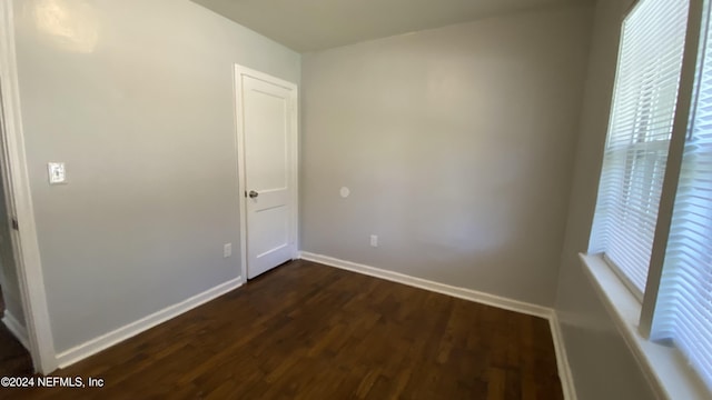 empty room with dark hardwood / wood-style floors