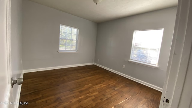 empty room with dark hardwood / wood-style floors