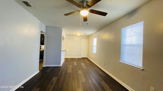 empty room featuring dark hardwood / wood-style flooring and ceiling fan