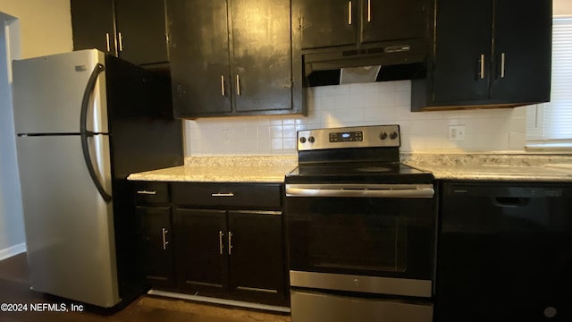 kitchen featuring light stone countertops, dark brown cabinetry, stainless steel appliances, and tasteful backsplash