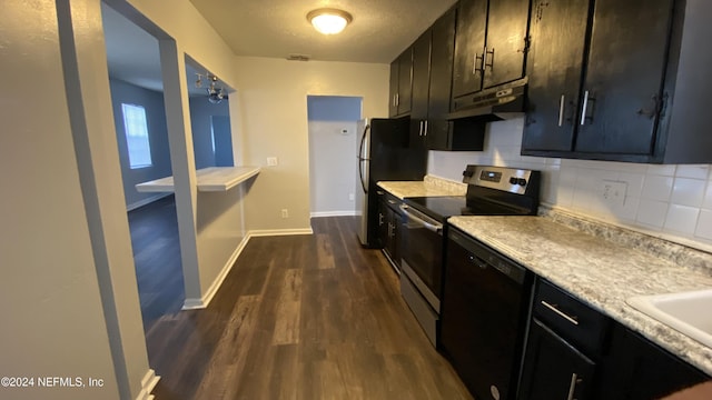 kitchen with a textured ceiling, decorative backsplash, dark hardwood / wood-style floors, and appliances with stainless steel finishes