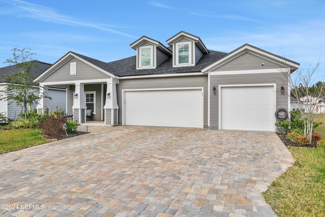 view of front of property with covered porch and a garage