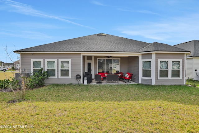 rear view of property featuring an outdoor living space, a yard, ceiling fan, and a patio