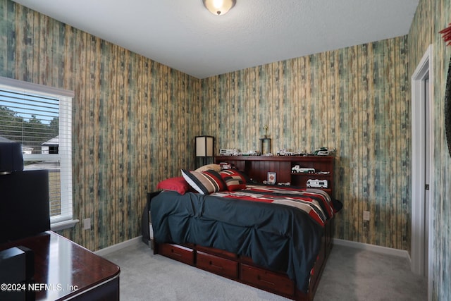 bedroom with carpet floors and multiple windows