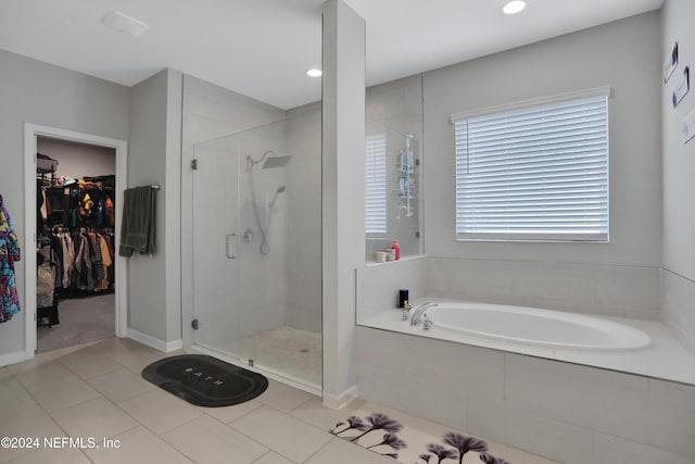 bathroom with tile patterned flooring and independent shower and bath