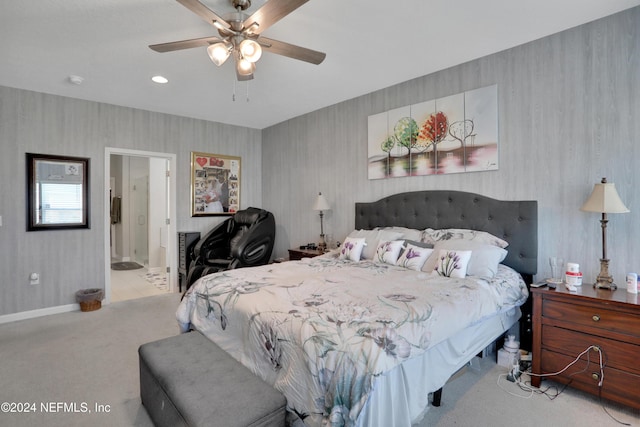 carpeted bedroom with ceiling fan and ensuite bath