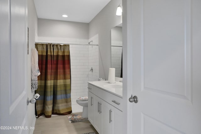 bathroom with toilet, vanity, hardwood / wood-style floors, and walk in shower