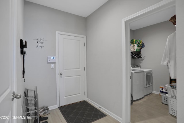 interior space featuring light hardwood / wood-style floors and separate washer and dryer