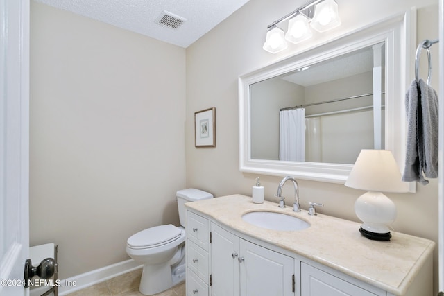 bathroom featuring a textured ceiling, vanity, tile patterned flooring, toilet, and curtained shower