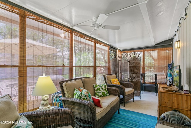 sunroom / solarium with ceiling fan and lofted ceiling