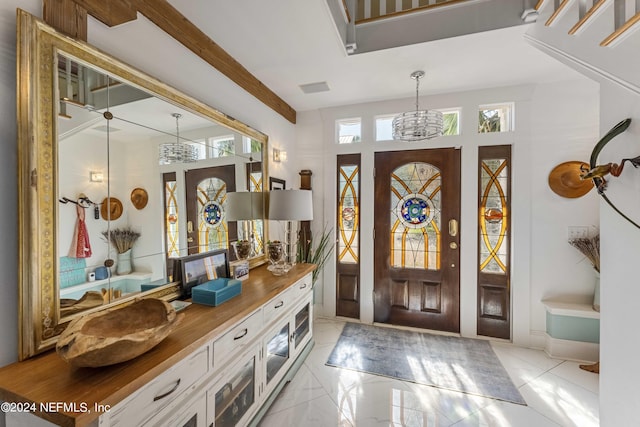 foyer entrance featuring plenty of natural light and an inviting chandelier