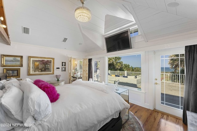 bedroom featuring access to outside, crown molding, vaulted ceiling, wood-type flooring, and a chandelier