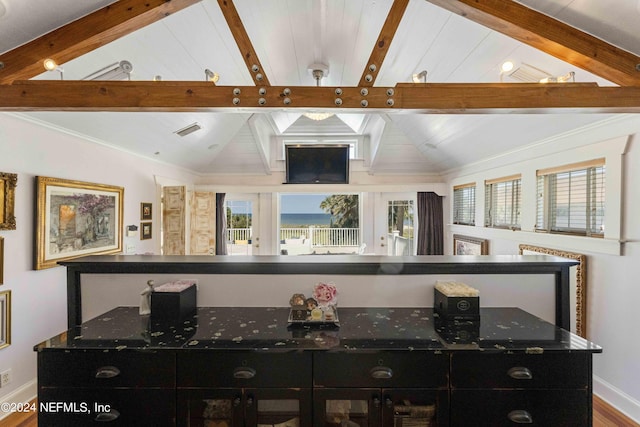 bar featuring vaulted ceiling with beams, a healthy amount of sunlight, and wood-type flooring