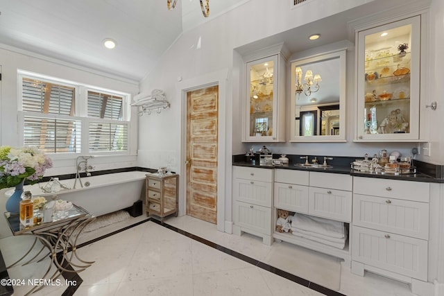 bathroom with tile patterned flooring, vanity, a bath, and an inviting chandelier