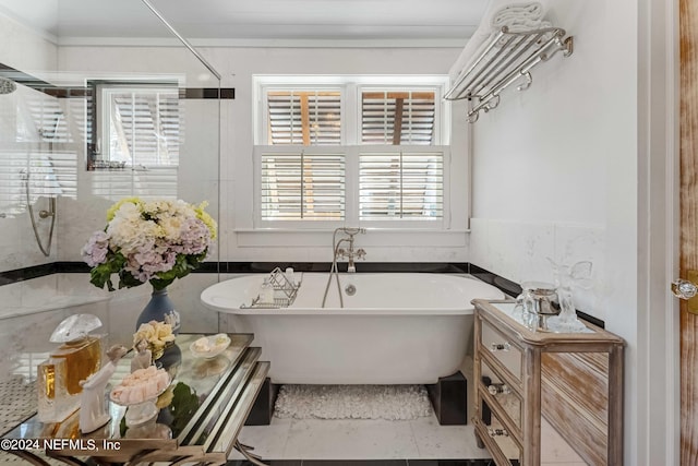 bathroom featuring separate shower and tub, tile patterned flooring, and a healthy amount of sunlight