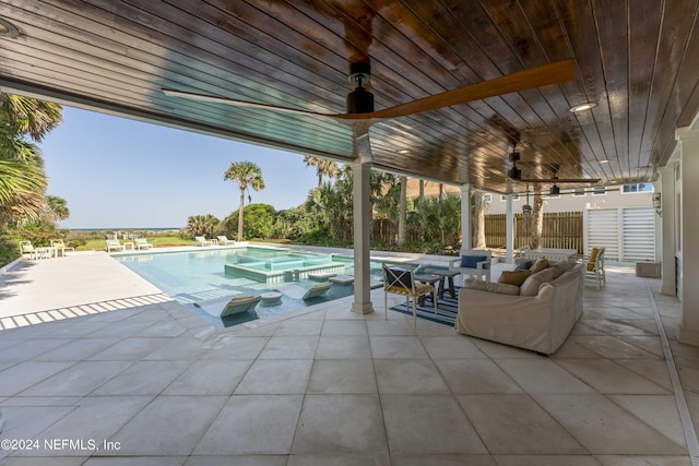 view of pool with a patio, a hot tub, and ceiling fan